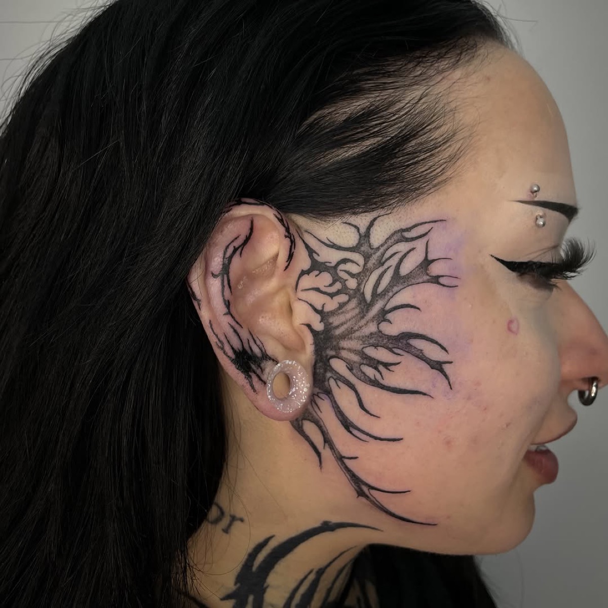Fine line face tattoo detail at Yes Electric Tattoo