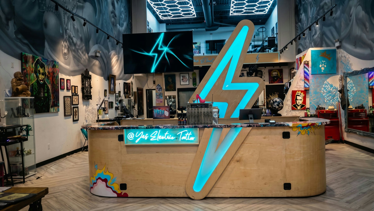 Wide view of Yes Electric tattoo studio floor, flash art walls and creative loft